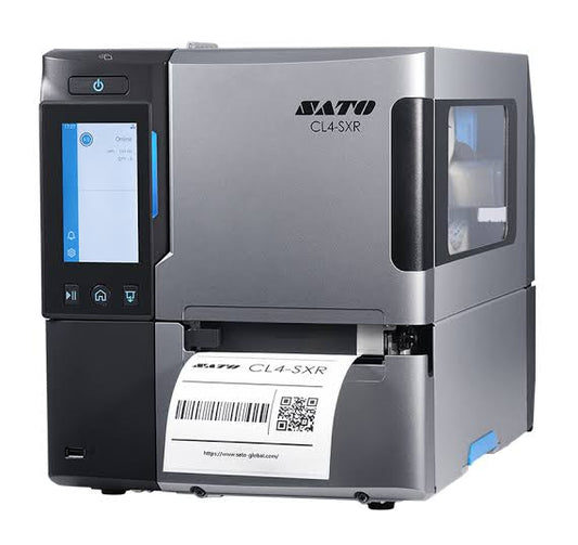 A silver and black SATO CL4-SXR industrial label printer with a built-in touchscreen display, a printed label tray, and a white label sheet emerging from the front, shown on a plain white background.