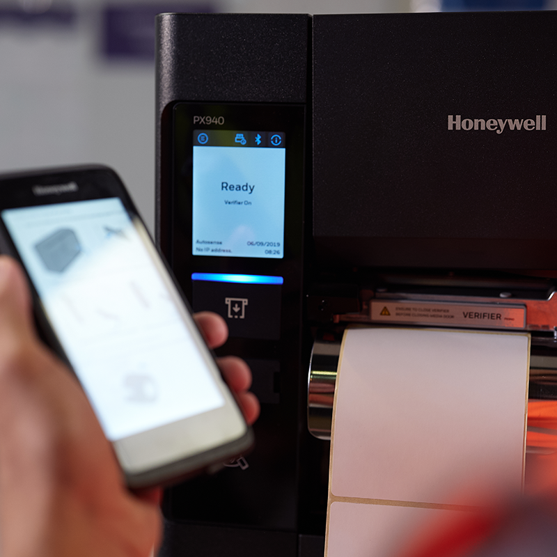 Honeywell PX940 scanner with smartphone scanning a label