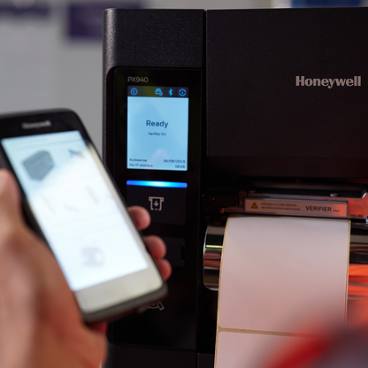 Honeywell PX940 scanner with smartphone scanning a label
